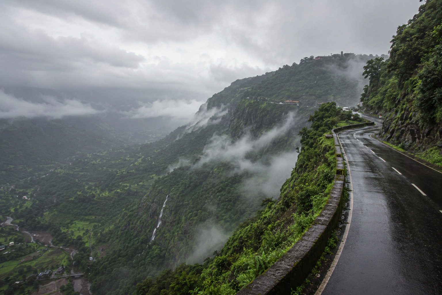 Misty Mountain Road Through Lush Valleys.png